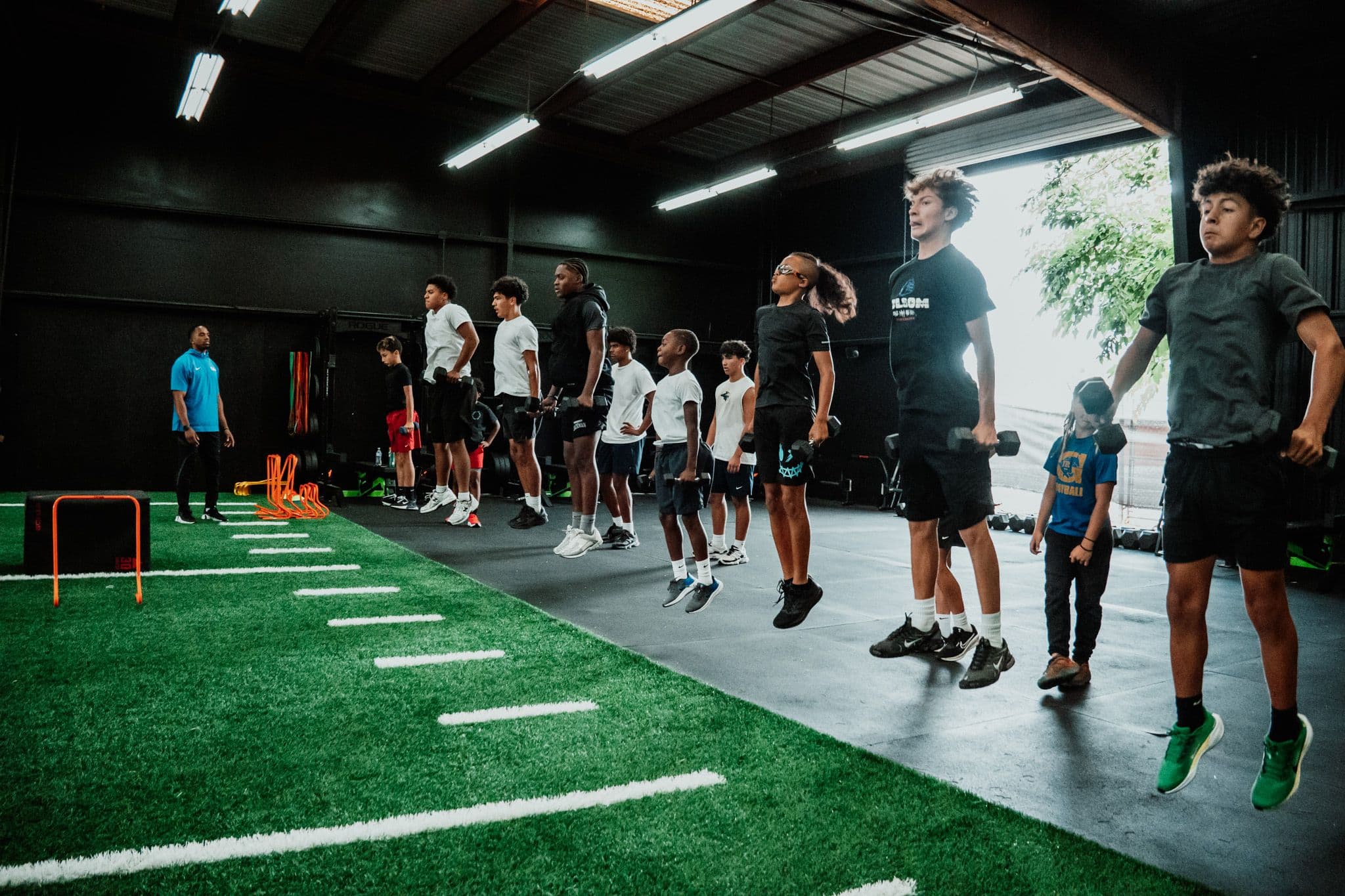 Student-athletes training with dumbbells